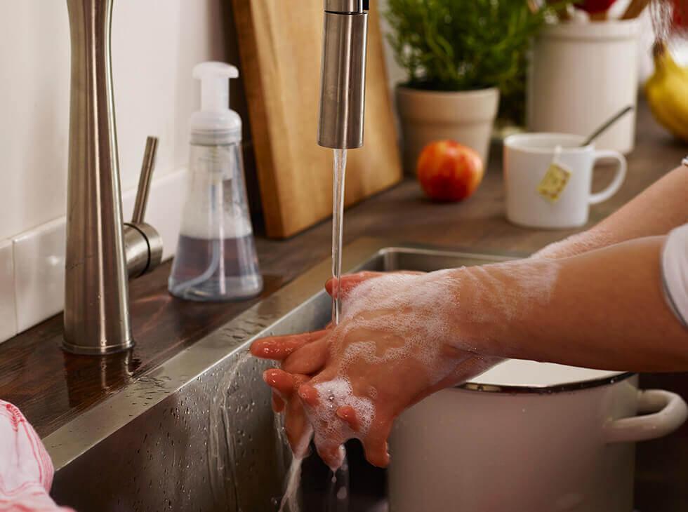 Hands being washed on a sink
